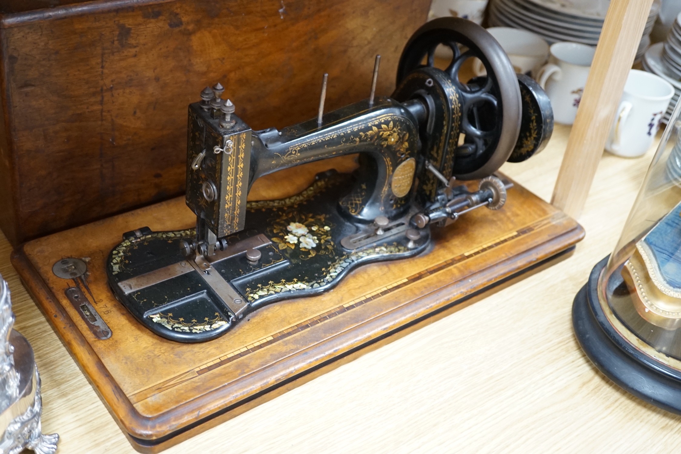 A 19th century mother of pearl decorated John Murdoch sewing machine with wooden case